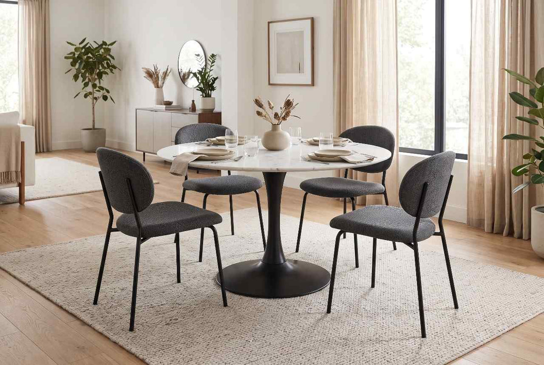 Modern upholstered dining chairs paired with a marble round pedestal table by LeisureMod.